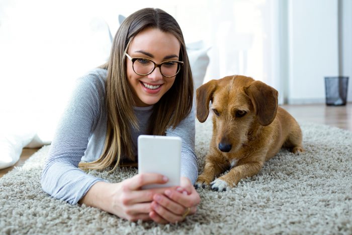 mujer en videollamada acompañada de su perro